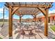 Inviting backyard patio featuring a pergola, lounge chairs, and a view of the pool, perfect for outdoor entertaining at 2699 E Claxton Rd, Gilbert, AZ 85297