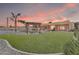 Lush backyard featuring artificial grass, a cozy pergola, and outdoor seating perfect for entertaining at 2699 E Claxton Rd, Gilbert, AZ 85297