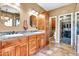 Bathroom featuring double sinks, granite countertops, and a walk-in closet at 2699 E Claxton Rd, Gilbert, AZ 85297