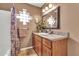 Bathroom featuring a vanity with ample counter space, wooden cabinetry, a framed mirror, and modern fixtures at 2699 E Claxton Rd, Gilbert, AZ 85297