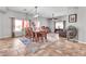 Dining area with large wooden table, colorful rug, and an open floor plan at 2699 E Claxton Rd, Gilbert, AZ 85297