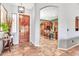 Foyer with dark wood door, tile flooring, and view of the kitchen at 2699 E Claxton Rd, Gilbert, AZ 85297