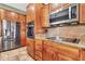Kitchen featuring stainless steel appliances, granite counters, and wooden cabinets at 2699 E Claxton Rd, Gilbert, AZ 85297
