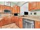 Kitchen featuring stainless steel appliances, granite counters, and wooden cabinets at 2699 E Claxton Rd, Gilbert, AZ 85297