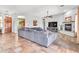 Spacious living room with tile floors, large couch, fireplace, ceiling fan, and views of the kitchen at 2699 E Claxton Rd, Gilbert, AZ 85297