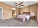 Cozy primary bedroom with carpet, a seating area, and an en-suite bathroom at 2699 E Claxton Rd, Gilbert, AZ 85297