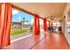 Covered patio with flowing drapes, ceiling fans, a dining table, lounge furniture, and views of the backyard at 2699 E Claxton Rd, Gilbert, AZ 85297