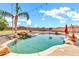 Inviting pool area with a waterfall feature, swaying palm trees, a basketball court, and a grassy lawn at 2699 E Claxton Rd, Gilbert, AZ 85297