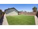 Large backyard features artificial grass, rock landscaping, and block wall for privacy at 3011 W Salter Dr, Phoenix, AZ 85027