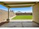 Inviting covered patio overlooking the expansive backyard with artificial turf and rock landscaping at 3011 W Salter Dr, Phoenix, AZ 85027