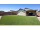 Large backyard with artificial turf, rock border, and a covered patio offering ideal outdoor living at 3011 W Salter Dr, Phoenix, AZ 85027