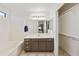 Bright bathroom featuring a vanity with a sink, a large mirror, and a tub/shower combination at 3011 W Salter Dr, Phoenix, AZ 85027