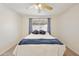 Comfortable bedroom with a ceiling fan, natural light, and a serene atmosphere at 3011 W Salter Dr, Phoenix, AZ 85027