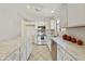 Bright kitchen featuring stainless steel appliances, white cabinetry and light, marble-look countertops at 3011 W Salter Dr, Phoenix, AZ 85027