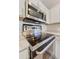 Close up of stainless steel oven and microwave appliances installed above a smooth cooktop at 3011 W Salter Dr, Phoenix, AZ 85027
