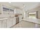 Well-lit kitchen with an island, stainless steel appliances, white cabinetry, and a dedicated workstation at 3011 W Salter Dr, Phoenix, AZ 85027