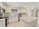 Bright kitchen featuring stainless steel appliances, white cabinetry and a center island with counter seating at 3011 W Salter Dr, Phoenix, AZ 85027