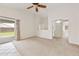 Spacious living room featuring neutral carpeting and a sliding glass door leading to the backyard at 3011 W Salter Dr, Phoenix, AZ 85027