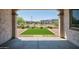 Backyard with artificial turf, rock landscaping, covered patio and wrought iron fence at 31570 N 123Rd Ln, Peoria, AZ 85383