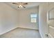 Neutral bedroom features a ceiling fan and a window at 31570 N 123Rd Ln, Peoria, AZ 85383