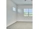Bright bedroom featuring plush carpet and large windows with views at 31570 N 123Rd Ln, Peoria, AZ 85383