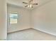 This bedroom offers neutral carpet and paint, ceiling fan, and a window that allows for great natural light at 31570 N 123Rd Ln, Peoria, AZ 85383
