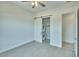 Bedroom with carpet, ceiling fan and closet with stacked washer and dryer at 31570 N 123Rd Ln, Peoria, AZ 85383