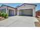 Single story home showcasing an open garage with ample parking space and well-maintained xeriscaping at 31570 N 123Rd Ln, Peoria, AZ 85383