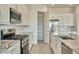 Kitchen featuring granite counters, stainless steel appliances, gas range, and walk-in pantry at 31570 N 123Rd Ln, Peoria, AZ 85383