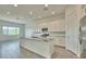 Bright kitchen with white cabinets, granite countertops, island and stainless steel appliances at 31570 N 123Rd Ln, Peoria, AZ 85383