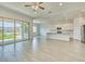 Open-concept living area featuring sleek tile floors and a spacious kitchen with an oversized island at 31570 N 123Rd Ln, Peoria, AZ 85383