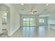 Spacious living room with tile floors, ceiling fan and large sliding glass doors to back patio at 31570 N 123Rd Ln, Peoria, AZ 85383