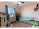 Pink themed bedroom with lots of natural light and playful décor at 3207 W Michigan Ave, Phoenix, AZ 85053