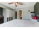 Bright bedroom with a ceiling fan, closet, and view of the en-suite bathroom at 3207 W Michigan Ave, Phoenix, AZ 85053