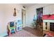 Bright, pink bedroom with toys, a play kitchen, and closet at 3207 W Michigan Ave, Phoenix, AZ 85053