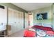 Cozy bedroom featuring a closet with shutter doors and green walls at 3207 W Michigan Ave, Phoenix, AZ 85053