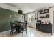 Well-lit dining room with a rustic light fixture and decorative 'gather' wall art at 3207 W Michigan Ave, Phoenix, AZ 85053