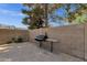 Backyard with brick pavers, a grill, and a privacy wall at 3825 E Captain Dreyfus Ave, Phoenix, AZ 85032