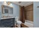 Cozy bathroom features a tiled shower, framed mirror, and blue vanity with marble countertop at 3825 E Captain Dreyfus Ave, Phoenix, AZ 85032