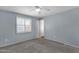 Cozy bedroom featuring a ceiling fan, a window with shutter, and neutral carpet at 3825 E Captain Dreyfus Ave, Phoenix, AZ 85032