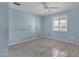 Bedroom featuring light blue walls, light-colored tile floor, and a bright window at 3825 E Captain Dreyfus Ave, Phoenix, AZ 85032