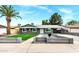 Charming single-story home with a well-manicured lawn and a classic desert landscape in a sunny, residential neighborhood at 3825 E Captain Dreyfus Ave, Phoenix, AZ 85032