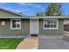 Inviting front entrance with a secure screen door, stone walkway, and freshly maintained landscaping at 3825 E Captain Dreyfus Ave, Phoenix, AZ 85032
