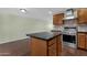 Kitchen featuring an island with granite countertop and stainless steel appliances at 3825 E Captain Dreyfus Ave, Phoenix, AZ 85032