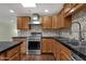 Bright kitchen featuring dark counters, stainless appliances, and tile backsplash at 3825 E Captain Dreyfus Ave, Phoenix, AZ 85032