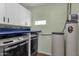 Laundry room with blue countertops, white cabinets, and matching washer and dryer at 3825 E Captain Dreyfus Ave, Phoenix, AZ 85032