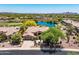 Aerial view of property showcasing sparkling community lake, desert landscaping, and tile roof at 41903 N Golf Crest Rd, Anthem, AZ 85086