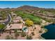 Breathtaking aerial view of lush golf course, community lake, desert landscaping, and sparkling pool at 41903 N Golf Crest Rd, Anthem, AZ 85086