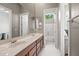 Bathroom with dual sinks, wood-look floors, and a separate room for the toilet and shower at 41903 N Golf Crest Rd, Anthem, AZ 85086