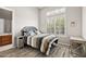 Bedroom features wood-look floors and a large window with shutter-style blinds at 41903 N Golf Crest Rd, Anthem, AZ 85086